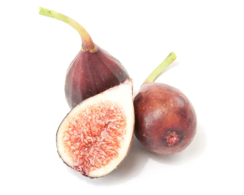 Closeup image of three 'Petite Negri' figs, one cut in half, showing dark purple skin and pink flesh.